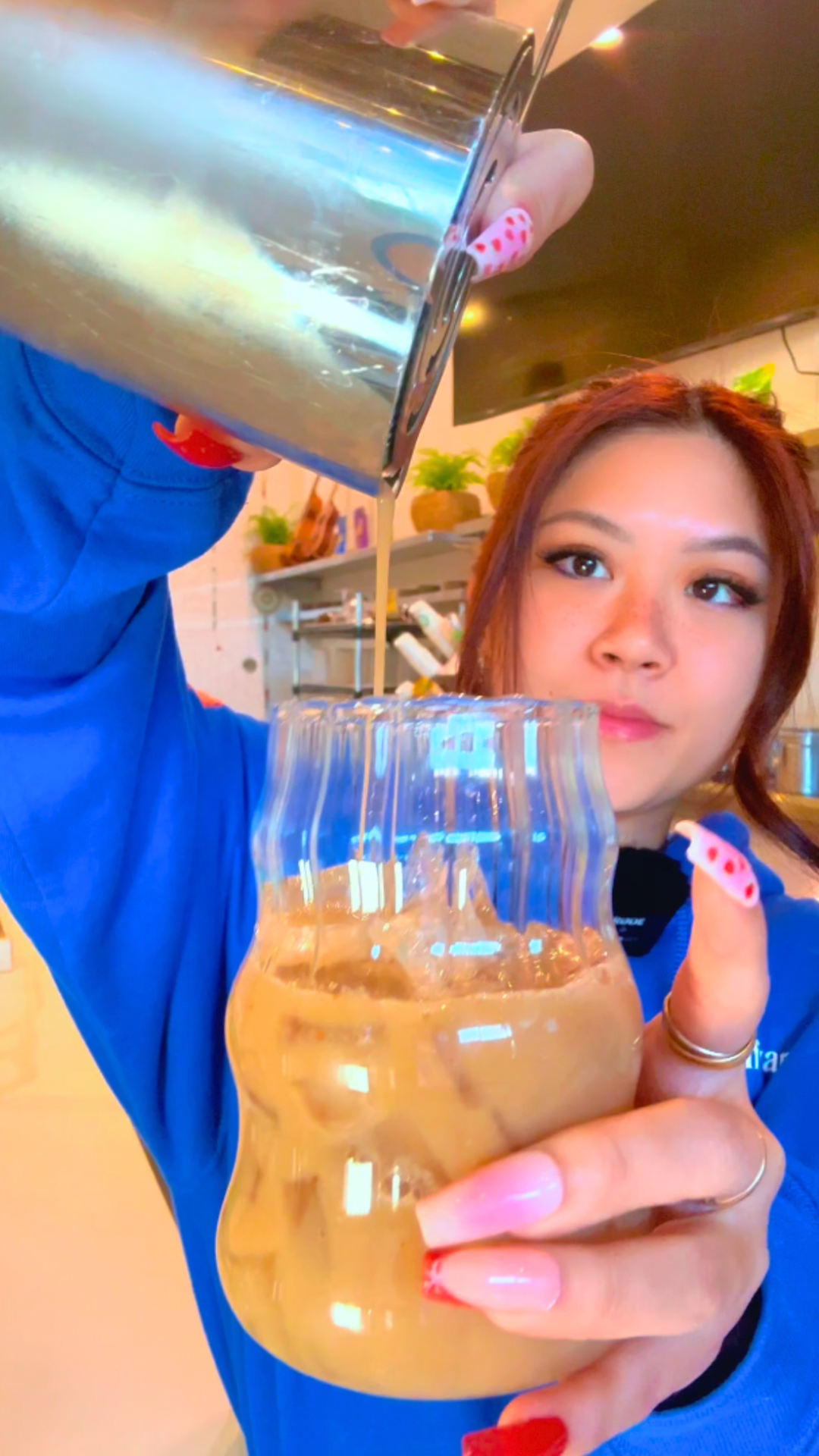 Pouring a Vanilla Cream Soda Kava Nectar drink from a shaker into a glass of ice at the Kavahana bar