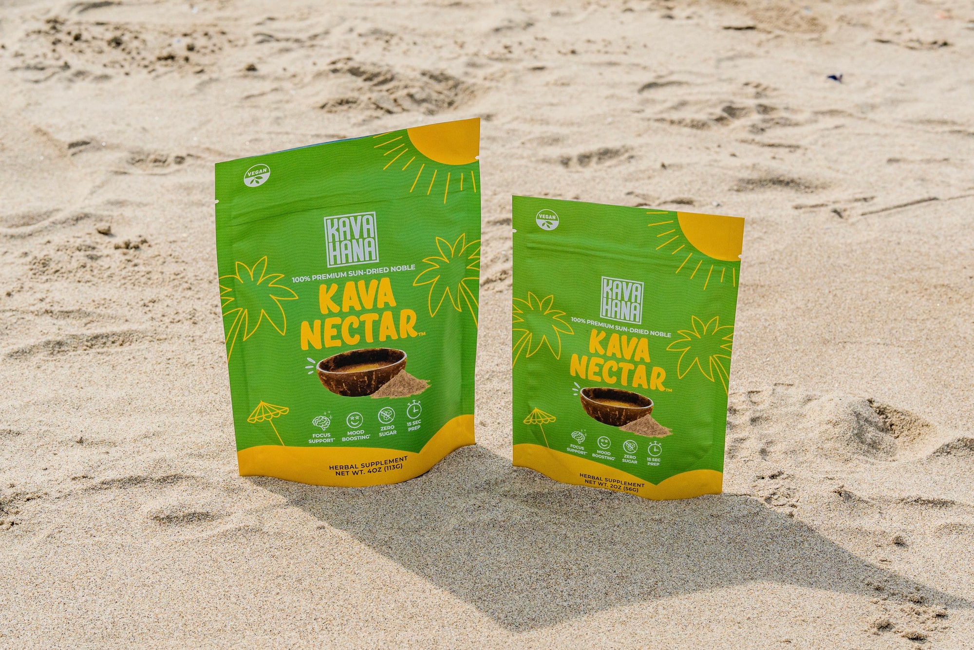 a photograph taken during daylight on the beach in santa monica california showing both sizes of kava nectar by kavahana in the sand.